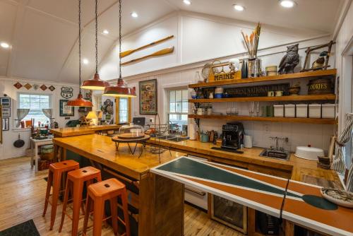 a large kitchen with a large wooden counter top at Camp DeForest in Lincolnville