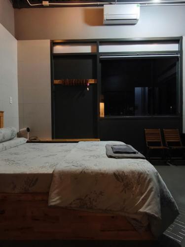 a large bed in a room with a large window at Long Homestay Mỹ Hạnh - Hotels in Ðức Hòa
