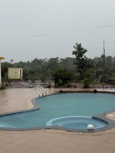 a large pool of water in a courtyard at Pali Retreat Riverside Stay with Pool in Pali