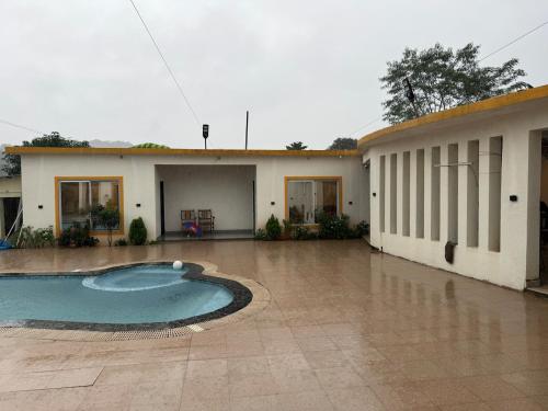a building with a swimming pool in front of it at Pali Retreat Riverside Stay with Pool in Pali