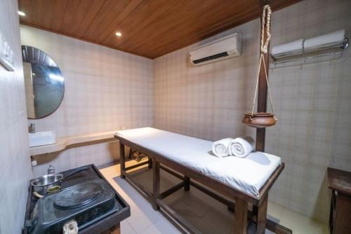 a room with a bench with towels on it at Neelam's The Grand Hotel Goa in Calangute
