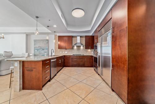 una cucina con armadietti in legno ed elettrodomestici in acciaio inossidabile di Turquoise Place Unit 802D a Orange Beach