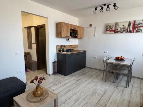 a living room with a table and a kitchen at Apartments Manzini in Koper