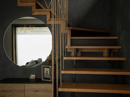 a spiral staircase in a room with a mirror at Mokre 22 in Bielsk Podlaski