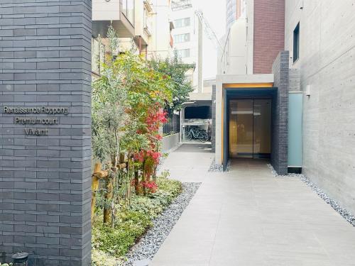 a walkway leading to a building with a door at Alo BnB 11 - Near Roppongi, Ginza, Shinjuku, Shibuya - Self check-in in Tokyo