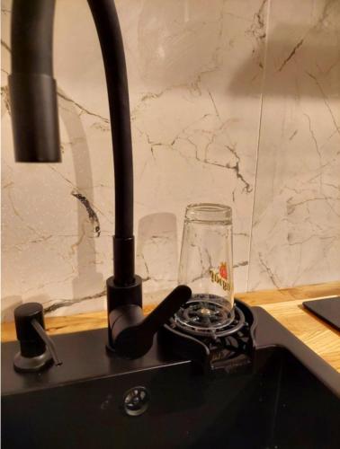 a lamp and a glass sitting on a counter at Apartament Reda z prywatną sauną lub antresolą in Reda