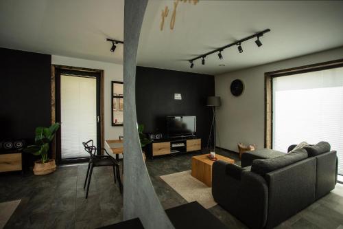 a living room with a couch and a tv at Mokre 22 in Bielsk Podlaski
