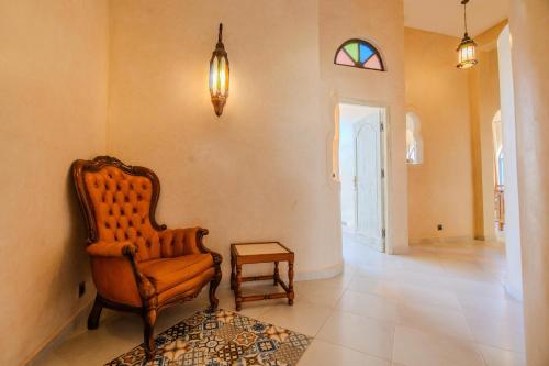 a living room with a chair and a table at Villa Sultana by Living Essaouira in Essaouira