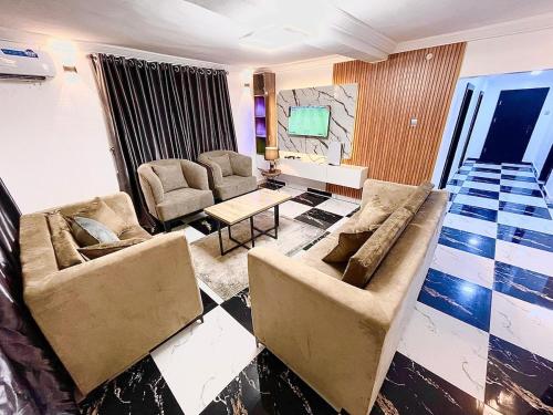 a living room with two couches and a table at Exquisite 3Bedroom in Ibadan in Ibadan