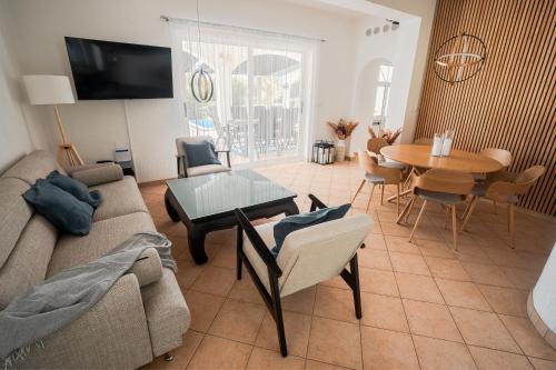 a living room with a couch and a table at Casa Bianca in Barbat na Rabu