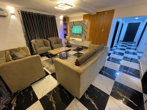 a living room with a couch and a table at Exquisite 3Bedroom in Ibadan in Ibadan