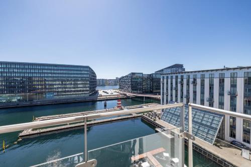 a view of a river in a city with buildings at Copenhagen Island Hotel in Copenhagen