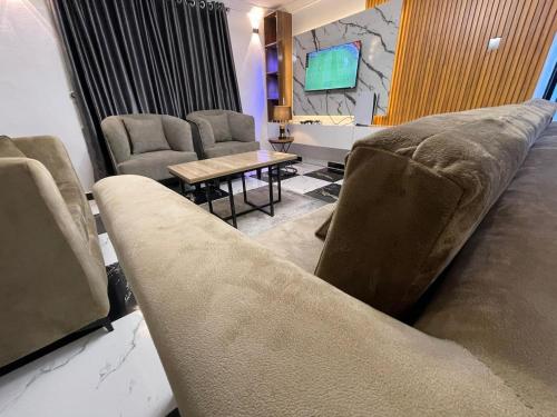a living room with a couch and chairs and a table at Exquisite 3Bedroom in Ibadan in Ibadan