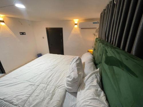 a bedroom with a large white bed in a room at Exquisite 3Bedroom in Ibadan in Ibadan