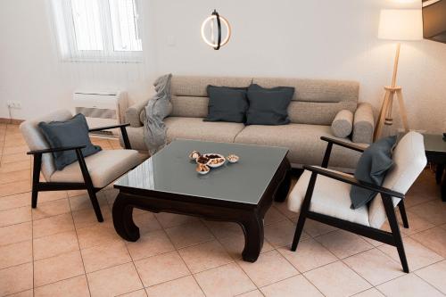a living room with a couch and a table and chairs at Casa Bianca in Barbat na Rabu