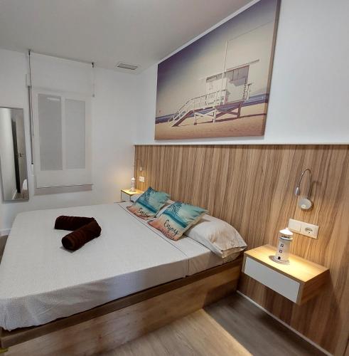 a bedroom with a bed and a picture on the wall at Beach House in Puerto de Mazarrón