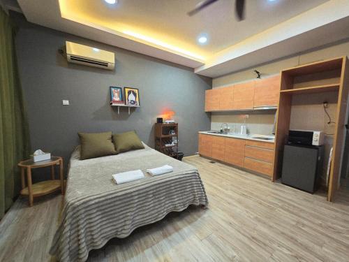 a bedroom with a bed with two towels on it at 028 Projector Palazio Vintage House Netflix Wifi in Johor Bahru