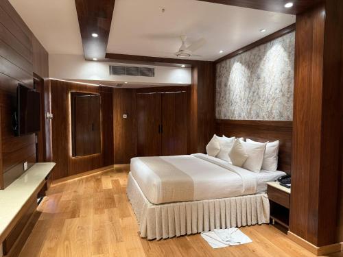 a hotel room with a bed and a television at Hotel the Plaza in Hyderabad