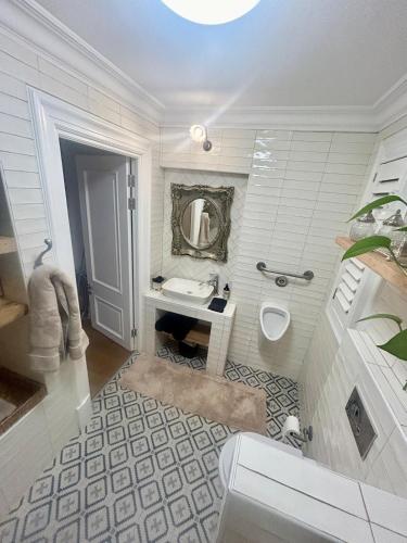 Un baño blanco con lavabo e inodoro. en French Manor 1, en Stellenbosch