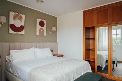 a bedroom with a white bed and a window at Hotel San Jorge in Nueva de Llanes