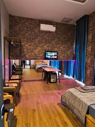 a room with two beds and a brick wall at Long Homestay Mỹ Hạnh - Hotels in Ðức Hòa