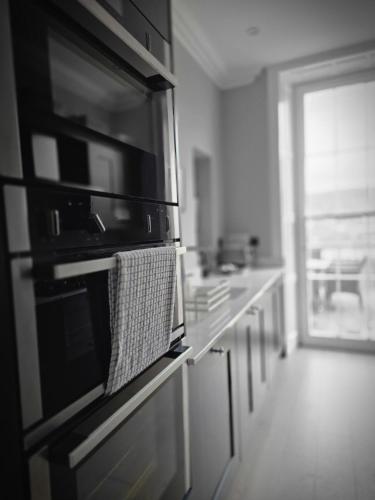 a kitchen with a microwave oven on a counter at Vintner Townhouse Artisan Quarter Bath in Bath