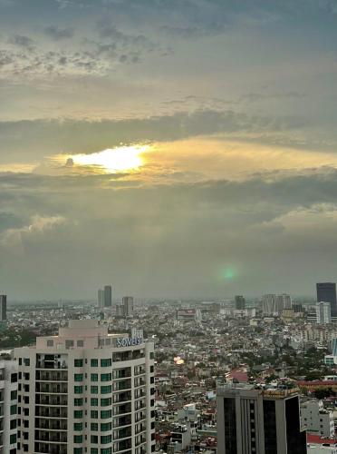 a view of a city with the sun in the sky at The Nest High-Floor Studio with City View in Ðông Khê