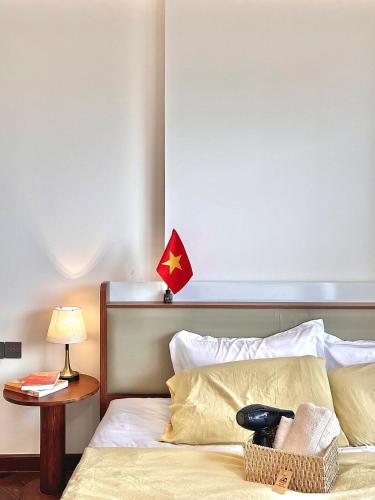 a hotel room with a bed with a red star above it at The Nest High-Floor Studio with City View in Ðông Khê
