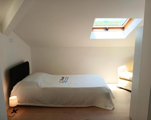 a bedroom with a bed and a skylight at CV017 - Milano Marittima, elegante mansarda con aria condizionata in Cervia