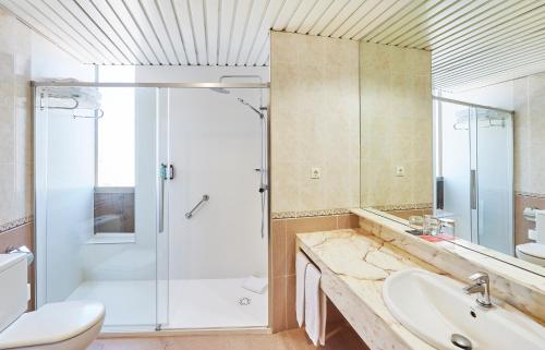 a bathroom with a shower and a sink and a toilet at Hesperia Sant Joan in Sant Joan Despí