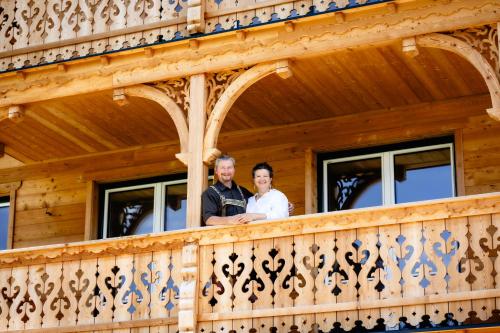 a man and woman standing on a balcony of a house at Lippingergut - Urlaub im Wolfgangseetal - Ferienwohnung EG in St. Wolfgang