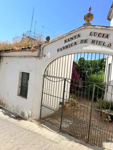 an old building with a gate in front of it at Apartamentos Molinos in Constantina