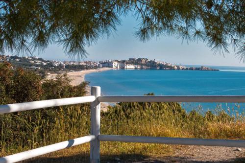 a view of a beach with a white fence at A Casa di Anna by BarbarHouse in Vieste