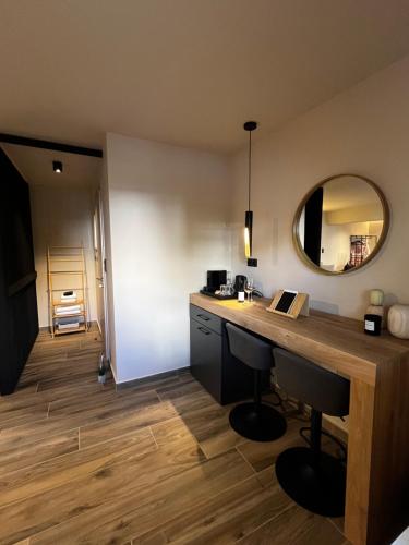 a room with a desk and a mirror on the wall at Χenion Inn - Athens Airport, Easy Check In Anytime in Markopoulo