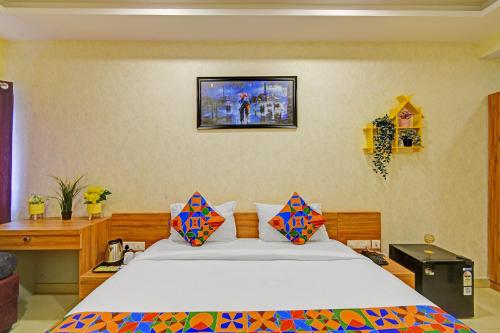 a bedroom with a bed and a tv on the wall at FabHotel Metro - Nr Secunderabad Railway Station in Hyderabad