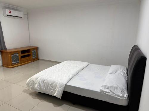 a bedroom with a bed and a night stand at Pretty's home in Ranau