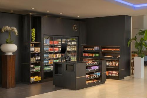 a room with a pharmacy with shelves of alcohol at Hilton Düsseldorf in Düsseldorf