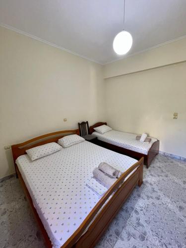 a bedroom with two beds and a light on the ceiling at Villa Festim Ksamil in Ksamil