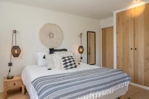 a bedroom with a bed with a black and white blanket at NEW Family Chic Design, Comfort & Outdoor Living - Free Parking Wifi in Knokke-Heist