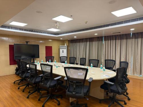 a large conference room with a large table and chairs at Hotel the Plaza in Hyderabad