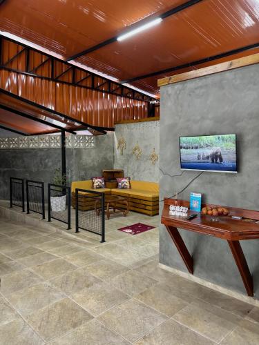 a lobby with a yellow couch and a table at Hotel São Francisco in São Francisco do Sul