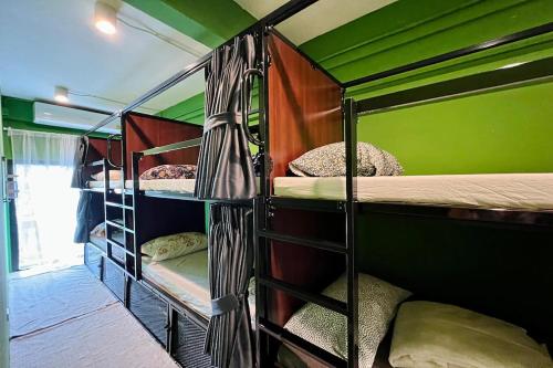 a group of bunk beds in a room at El Biografo in Bangkok