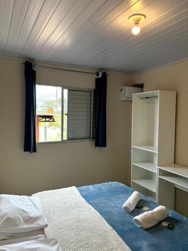 a bedroom with a bed and a window in it at Hotel São Francisco in São Francisco do Sul