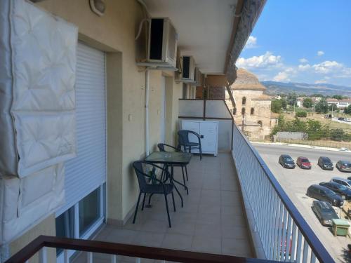 a balcony with chairs and tables on a building at Απολαύστε τη διαμονή σας στις Σέρρες in Serres