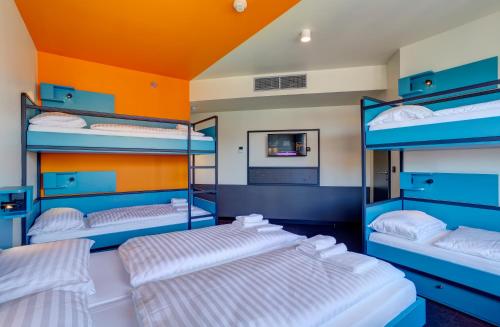 a room with four bunk beds in it at MEININGER Budapest Great Market Hall in Budapest
