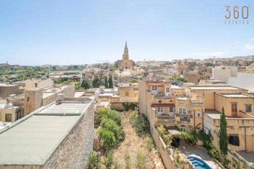 an aerial view of a city with buildings at Ghajnsielem 4BR Home with Wifi, AC and comfy beds by 360 Estates in Għajnsielem