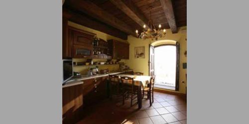 a kitchen with a table and chairs and a window at Bed and Breakfast Vùa in Bova