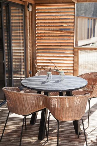 a table and chairs on a patio at Camping Le Florenville in Florenville