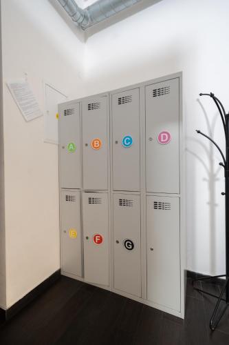 a row of lockers in a white room at Wellness Hostel Central in Prague