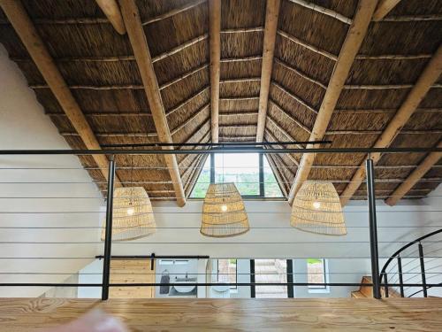 two lights hanging from the ceiling of a room at Bayview Bliss at Springerbaai in Mossel Bay